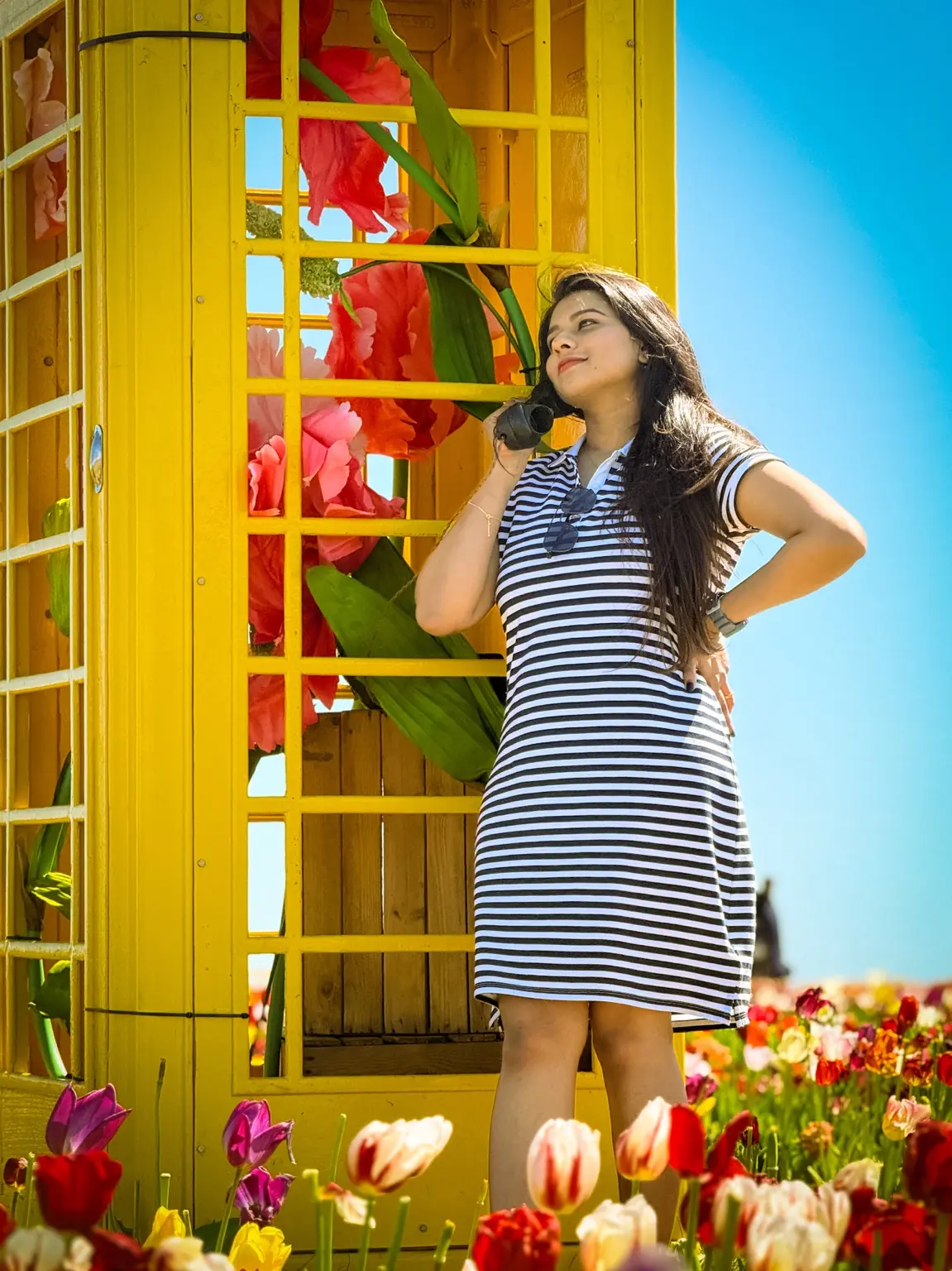Colourful portrait beside a yellow telephone box